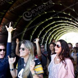 Excited attendees enter the event through the tunnel.