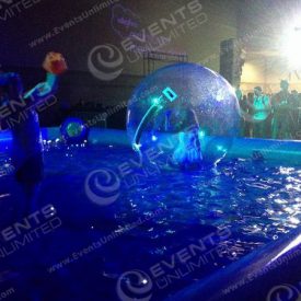 Custom Indoor Pool with floating sphere and interpretive dance performance.