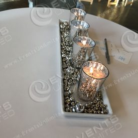 This mercury glass candle centerpiece was put together by our in house decor team.