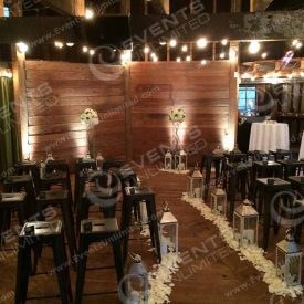 We transformed this old barn into a beautiful wedding chapel- provided bistro lighting, cool stools, floral, lighting, and more!